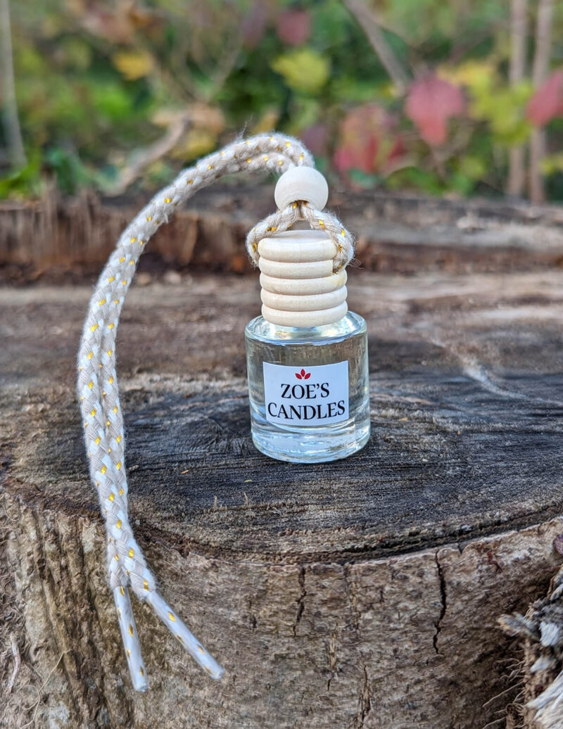 A car diffuser on top of a wooden area